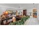 Open living room with hardwood floors, a view of the pool, and kitchen access at 2516 Roberta St, Largo, FL 33771