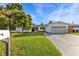 Charming single-story home with a two-car garage and manicured lawn at 2516 Roberta St, Largo, FL 33771
