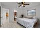 Bedroom with queen bed, private bathroom access and ceiling fan at 2516 Roberta St, Largo, FL 33771