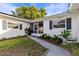 Bright white house exterior with walkway and landscaping at 2516 Roberta St, Largo, FL 33771