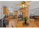 Kitchen with light wood cabinets, tile floors and a dining area at 2516 Roberta St, Largo, FL 33771