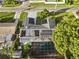 Aerial view showcasing home with solar panels and a screened pool at 2516 Roberta St, Largo, FL 33771