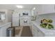 Modern white kitchen with marble countertops and stainless steel appliances at 270 Independence Ave # 10, Palm Harbor, FL 34684