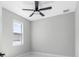 Simple bedroom with ceiling fan and window at 2714 W Walnut St, Tampa, FL 33607