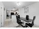 Bright dining area with a black glass table and four black chairs at 3332 W Heiter St, Tampa, FL 33607