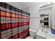 Bathroom with toilet, sink, and geometric shower curtain at 3332 W Heiter St, Tampa, FL 33607