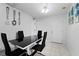 Dining area with a black glass table and four black chairs, near entrance at 3332 W Heiter St, Tampa, FL 33607