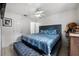 Main bedroom with a king-size bed and blue bedding at 3332 W Heiter St, Tampa, FL 33607