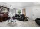 Living room features a black leather couch and a piano at 3332 W Heiter St, Tampa, FL 33607