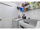 Laundry room with washer, dryer, and shelving at 3332 W Heiter St, Tampa, FL 33607