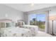 Bright bedroom features twin beds, a ceiling fan, and a view of the outdoors at 4900 Brittany S Dr # 314, St Petersburg, FL 33715