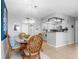 Cozy dining area features a glass table, wicker chairs, and stylish pendant lighting at 4900 Brittany S Dr # 314, St Petersburg, FL 33715