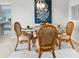 Intimate dining space features a glass table, wicker chairs, and elegant decor at 4900 Brittany S Dr # 314, St Petersburg, FL 33715