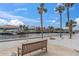Peaceful waterfront view with a park bench and palm trees at 4900 Brittany S Dr # 314, St Petersburg, FL 33715