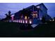 House exterior and backyard at night with landscape lighting at 5307 Wishing Arch Dr, Apollo Beach, FL 33572