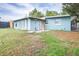 Single story home with a light blue exterior and a well maintained lawn at 6730 Sandra Dr, Port Richey, FL 34668