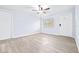 Spacious bedroom with ceiling fan and wood-look flooring at 6730 Sandra Dr, Port Richey, FL 34668