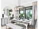 Elegant dining room featuring a large table and modern chandelier at 759 Steel Dr, Apollo Beach, FL 33572