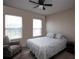 Bedroom with ceiling fan, queen bed, and window seating at 8519 Sunshower Pl, Parrish, FL 34219