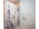 Clean bathroom with nautical-themed shower curtain and modern fixtures at 8519 Sunshower Pl, Parrish, FL 34219