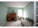 Home office with a roll top desk and comfortable sofa at 8519 Sunshower Pl, Parrish, FL 34219