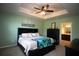 Main bedroom with king bed, access to the bathroom, and a calming color scheme at 8519 Sunshower Pl, Parrish, FL 34219