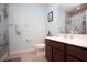 Bright bathroom featuring a brown vanity and updated shower at 8519 Sunshower Pl, Parrish, FL 34219