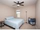 Cozy bedroom with a light blue comforter and ceiling fan at 8519 Sunshower Pl, Parrish, FL 34219