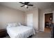 Bedroom with ceiling fan, queen bed, and ample closet space at 8519 Sunshower Pl, Parrish, FL 34219