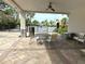 Covered patio area with table and chairs near pool at 8519 Sunshower Pl, Parrish, FL 34219