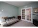 Relaxing home office with a daybed and French doors at 8519 Sunshower Pl, Parrish, FL 34219