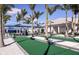 Outdoor bocce ball court with palm trees and covered seating area at 9430 Shorebird Ct, Parrish, FL 34219