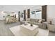 Bright, open-concept living room and kitchen features modern decor and wood-style flooring at 9430 Shorebird Ct, Parrish, FL 34219