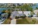 Aerial view of a waterfront home with a private dock and lush landscaping at 15918 Redington Dr, Redington Beach, FL 33708