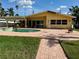 Backyard features a pool, brick patio, and access to outdoor bar for entertaining at 15918 Redington Dr, Redington Beach, FL 33708