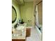 Modest bathroom featuring a granite countertop sink and a shower-tub combination at 15918 Redington Dr, Redington Beach, FL 33708