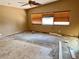 Bedroom needing renovation, featuring bare floors and a single window with a ceiling fan at 15918 Redington Dr, Redington Beach, FL 33708