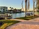 Beautiful waterfront property with brick patio, lush lawn and a private dock at 15918 Redington Dr, Redington Beach, FL 33708