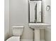 Modern half bathroom showcasing a pedestal sink and sleek mirror at 18096 Foxtail Loop, Venice, FL 34293