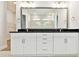 Bright bathroom with double vanity, modern lighting, and large mirror at 18096 Foxtail Loop, Venice, FL 34293