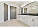 Modern bathroom with double vanity, white cabinets, and hexagon tile flooring at 18096 Foxtail Loop, Venice, FL 34293