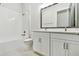 Neat bathroom featuring a tiled tub-shower combo, double vanity with modern fixtures, and tile floors at 18096 Foxtail Loop, Venice, FL 34293