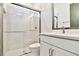 This modern bathroom features a glass enclosed shower, single vanity and brushed nickel finishes at 18096 Foxtail Loop, Venice, FL 34293