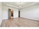 Spacious main bedroom with wood floors and entry to ensuite bathroom at 18096 Foxtail Loop, Venice, FL 34293