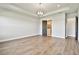 Open main bedroom with wood floors and modern light fixture at 18096 Foxtail Loop, Venice, FL 34293