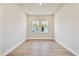 Bright and airy bedroom with natural light, hardwood floors, and a view of the neighborhood at 18096 Foxtail Loop, Venice, FL 34293