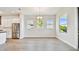 Dining area with stainless steel appliances and three bright windows at 18096 Foxtail Loop, Venice, FL 34293