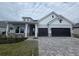 Charming single-Gathering home featuring a two-car garage, stone accents, and well-manicured lawn at 18096 Foxtail Loop, Venice, FL 34293