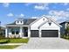 Charming home with a two-car garage, stone accents, and a well-manicured lawn at 18096 Foxtail Loop, Venice, FL 34293