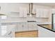 Bright kitchen with white cabinets, stainless steel appliances, and a gas cooktop at 18096 Foxtail Loop, Venice, FL 34293